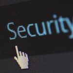 Close-up view of a mouse cursor over digital security text on display.